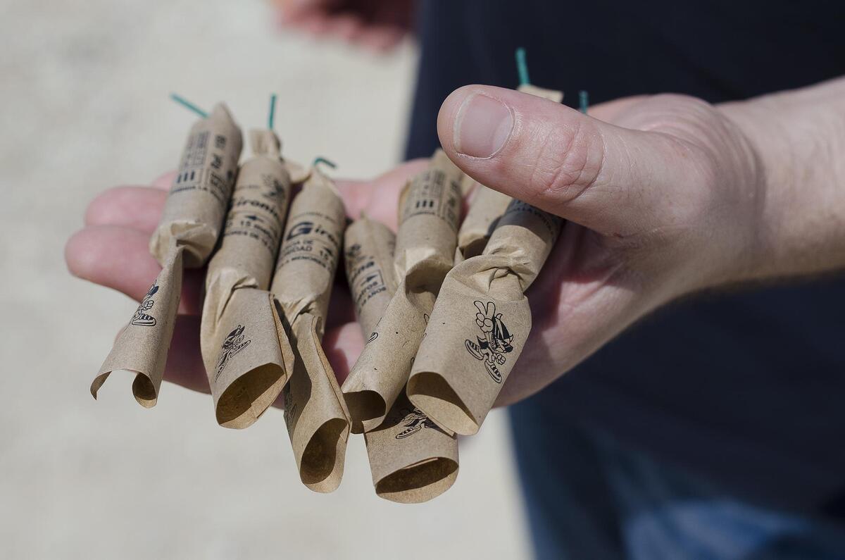 Firecrackers in person's hand